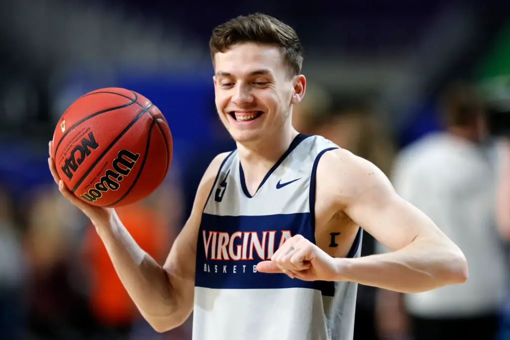 NCAA player grinning with basketball